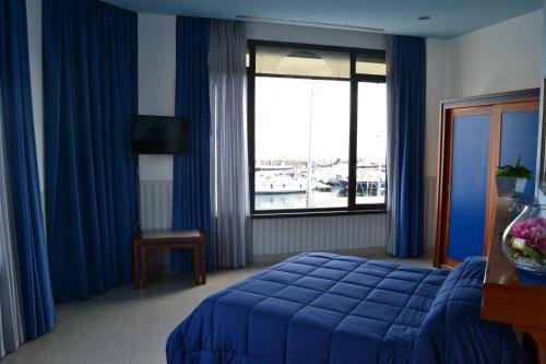 a hotel room with a bed and a window at Transatlantico in Naples