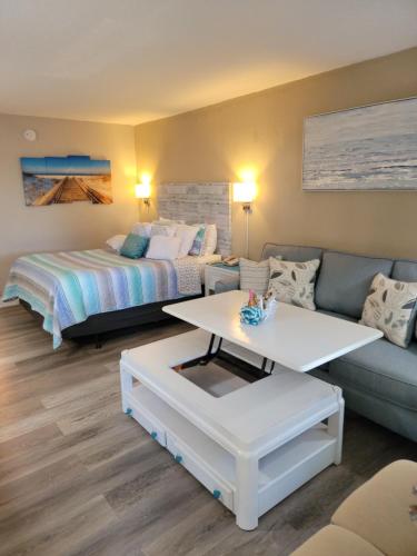 a living room with a bed and a couch at Getaway At The Marina in Sarasota