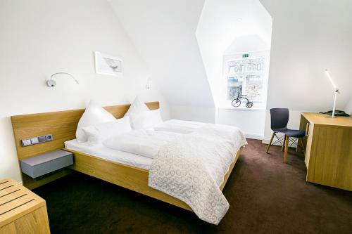 Schlafzimmer mit einem Bett, einem Schreibtisch und einem Stuhl in der Unterkunft Schloss Hotel Burgbrohl in Burgbrohl