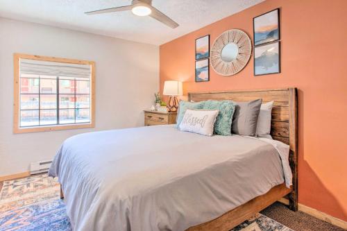 a bedroom with a large bed with an orange wall at Red River Retreat Walk to Lifts, Mtn Views! in Red River