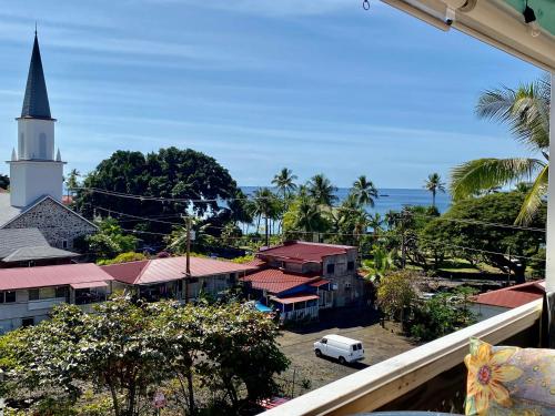 a view of a small town with a church and the ocean at Da Kona West 305 in Kailua-Kona
