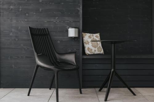 a black chair next to a table with a pillow at Kickmaier's in Kirchbach in Steiermark