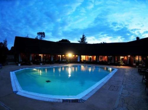 a large swimming pool in front of a building at Naro Moru River Lodge in Naro Moru