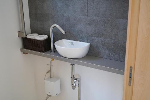 a bathroom with a sink and a mirror at Beach SPA TSUDA 0 Cero棟 in Sanuki