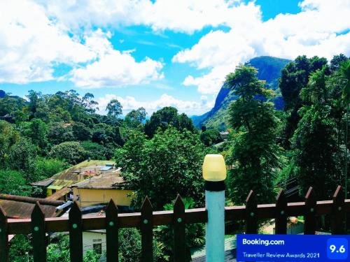 a fence with a view of a mountain at Poomaz Peace Palace in Ella