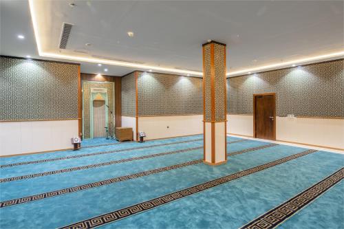 a large room with a pool and a pool at Roots Hotel in Makkah
