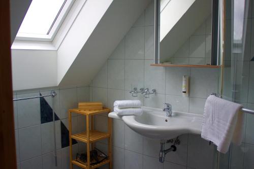 a bathroom with a sink and a skylight at Pension Lammerhof in Unterlamm