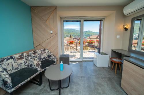 a living room with a couch and a table and a window at Darija Apartments - City Square in Ohrid