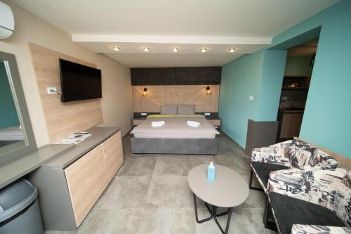 a bedroom with a bed and a couch and a table at Darija Apartments - City Square in Ohrid
