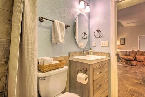 a bathroom with a toilet and a sink and a mirror at St Charles Hilltop Mansion with Mod Interior! in Hanley