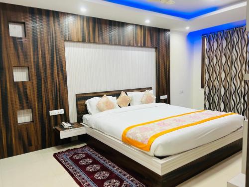 a bedroom with a large bed in a room at Bodhgaya Regency Hotel in Bodh Gaya