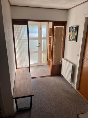 a room with a wooden table and a door at Nice villa near nature and the city in Silkeborg