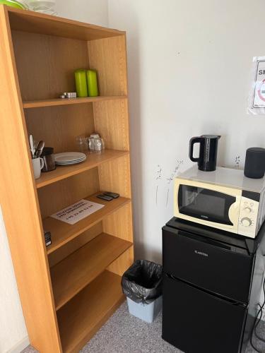 a kitchen with a microwave on top of a refrigerator at Nice villa near nature and the city in Silkeborg