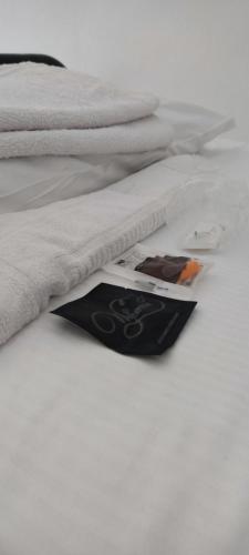 a book laying on a bed with a white blanket at Ostello ninin de ma' in Framura