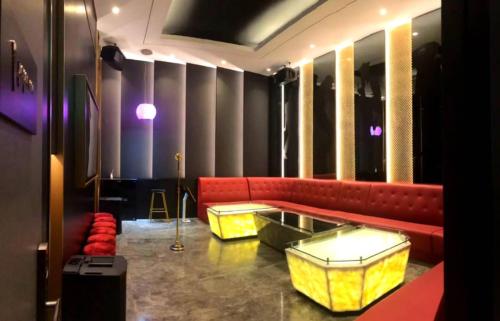 a room with red and yellow couches and a table at Star Luxury Suites KLCC in Kuala Lumpur