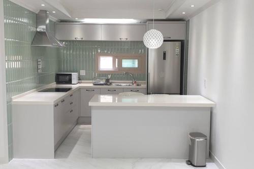 a kitchen with a white counter and a sink at Gyeongju Sugi's Guesthouse in Gyeongju