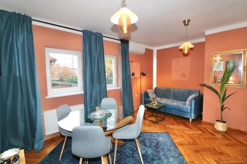 a living room with a couch and a table and chairs at Studio City in Ljubljana