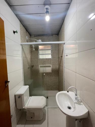 a bathroom with a toilet and a sink at Pousada Maranata in Bragança Paulista