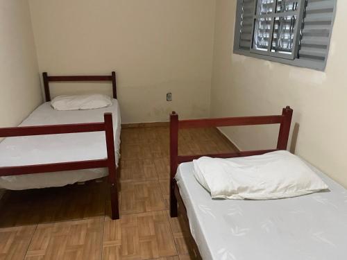 a room with two bunk beds and a window at Pousada Maranata in Bragança Paulista