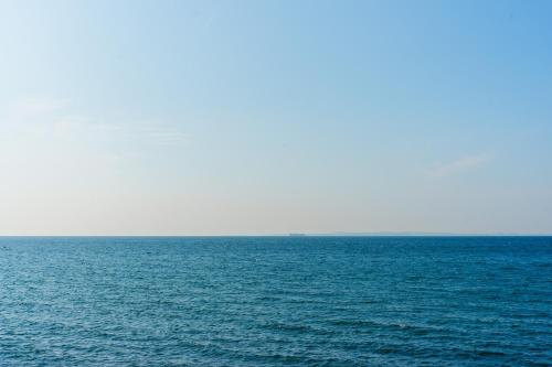 a large body of water with a boat in the distance at Ryu shi ma Ocean View Villa in Kyonan