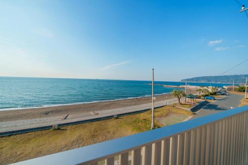 a view of the beach from the balcony of a condo at Ryu shi ma Ocean View Villa in Kyonan