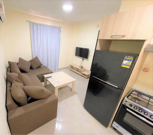 a small living room with a couch and a refrigerator at The view 43 - C4 in Sharm El Sheikh