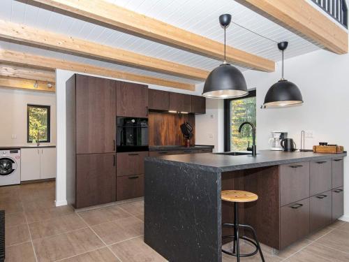 a kitchen with wooden cabinets and a black counter top at 6 person holiday home in Hovborg-By Traum in Hovborg