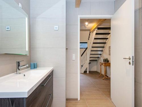 a bathroom with a sink and a staircase at 6 person holiday home in Hovborg-By Traum in Hovborg