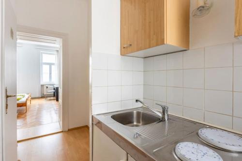 a kitchen with a sink and a counter top at vintage living in the heart of Vienna. in Vienna