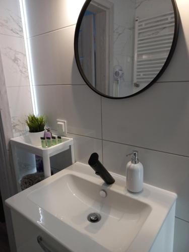 bagno con lavandino bianco e specchio di Apartament River Skierniewice a Skierniewice