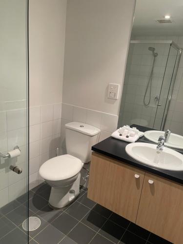 a bathroom with a toilet and a sink and a shower at 96 North Terrace Embassy Apartment in Adelaide
