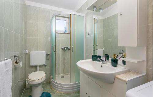 a bathroom with a toilet and a sink and a shower at Beautiful Apartment In Krk With Kitchen in Krk