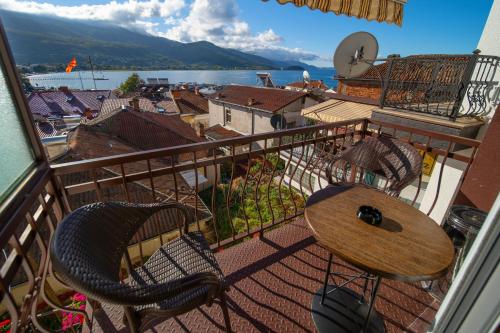 a balcony with a table and chairs and a view at Darija Apartments - City Square in Ohrid