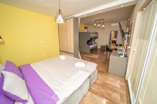 a room with a bed and a living room at Darija Apartments - City Square in Ohrid
