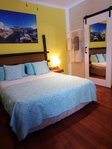 a bedroom with a large bed in a room at Khashamongo B & B in Somerset West