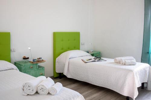 a room with two beds with towels on them at B&B da Baba in Ghizzano