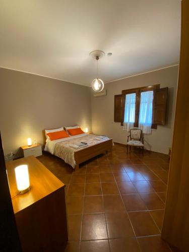 a bedroom with a bed and a chair in it at Villa Franca in Reggio Calabria