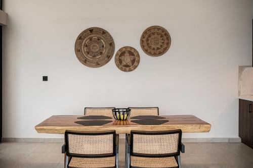 a dining room table with chairs and plates on the wall at ZeusCave in Georgioupolis