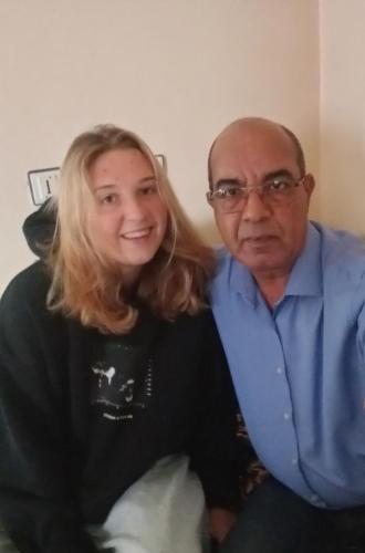a woman and an older man sitting on a couch at Airport Agadir Guest House in Agadir