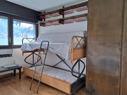 a bunk bed in a room with a window at La Thuile bilocale frazione. Entrèves in La Thuile