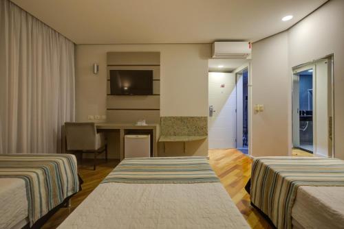 Ένα ή περισσότερα κρεβάτια σε δωμάτιο στο Viale Cataratas Hotel & Eventos