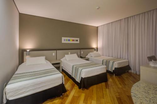 Ένα ή περισσότερα κρεβάτια σε δωμάτιο στο Viale Cataratas Hotel & Eventos