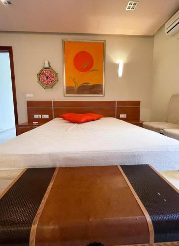 a bedroom with a large bed with an orange pillow at Casa Emma in Playa Honda