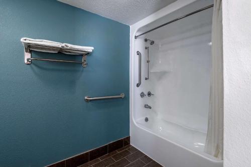 a bathroom with a shower and a white tub at Sleep Inn - Salisbury I-85 in Salisbury