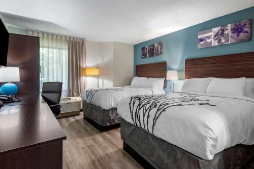 um quarto de hotel com duas camas e uma secretária em Sleep Inn - Salisbury I-85 em Salisbury