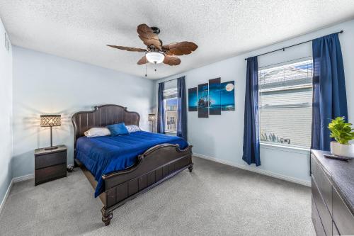 a bedroom with a bed and a ceiling fan at Pirate's Hideaway in Gulf Shores