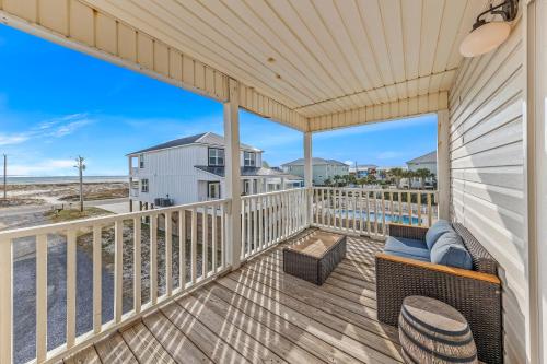 a view from the balcony of a unit with a couch and chairs at Pirate's Hideaway in Gulf Shores