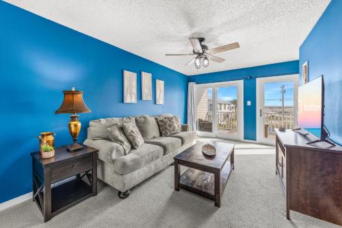 a living room with a couch and a tv at Pirate's Hideaway in Gulf Shores