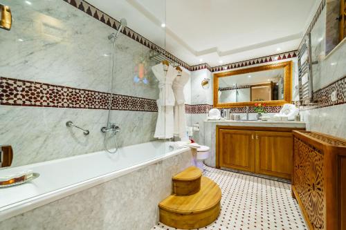 a bathroom with a tub and a sink at Riad Rcif Alif Suite & SPA in Fès