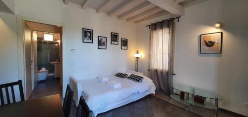 a bedroom with a bed and a table and a window at Residence Ki House in Parma